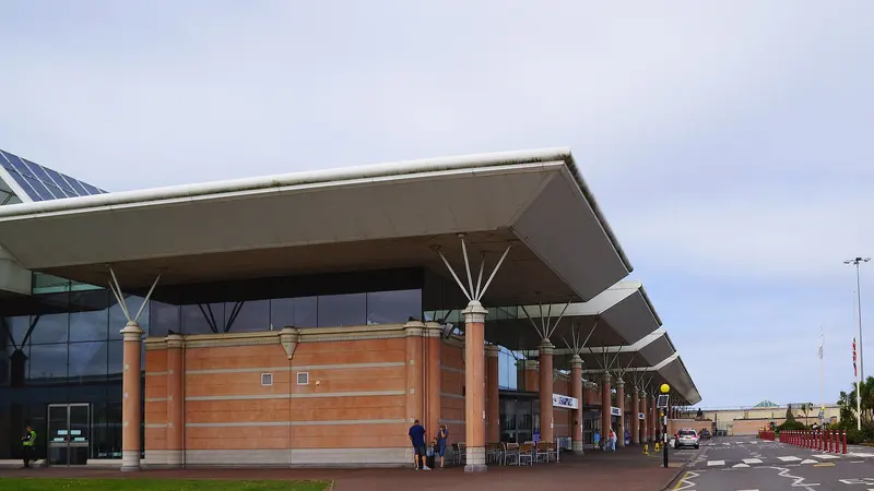 The modern terminal building at Jersey Airport with a sweeping canopy roof